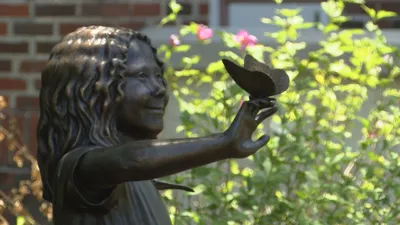 Sculpture of a girl holding a butterfly at the Mary C in Ocean Springs, by Lindsay Lacroix Peichl