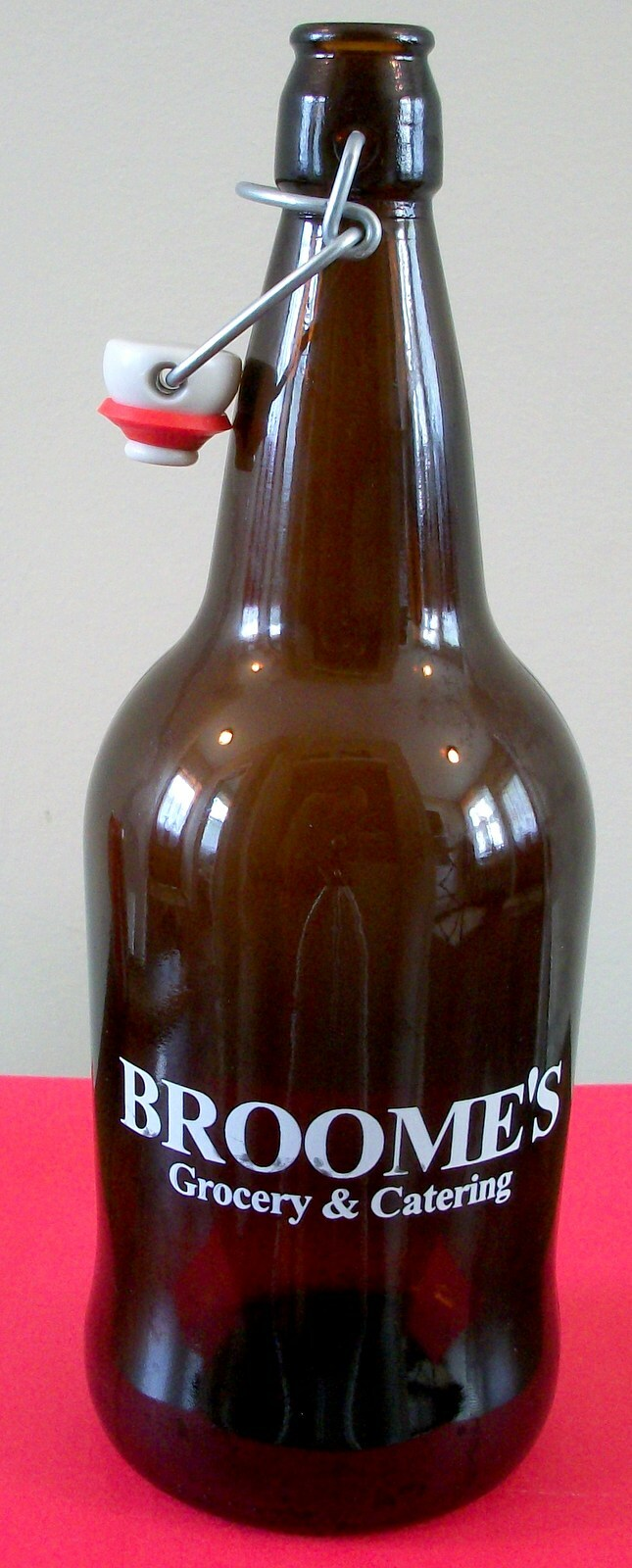 Brown swing-top bottle embossed Broome’s Grocery and Catering