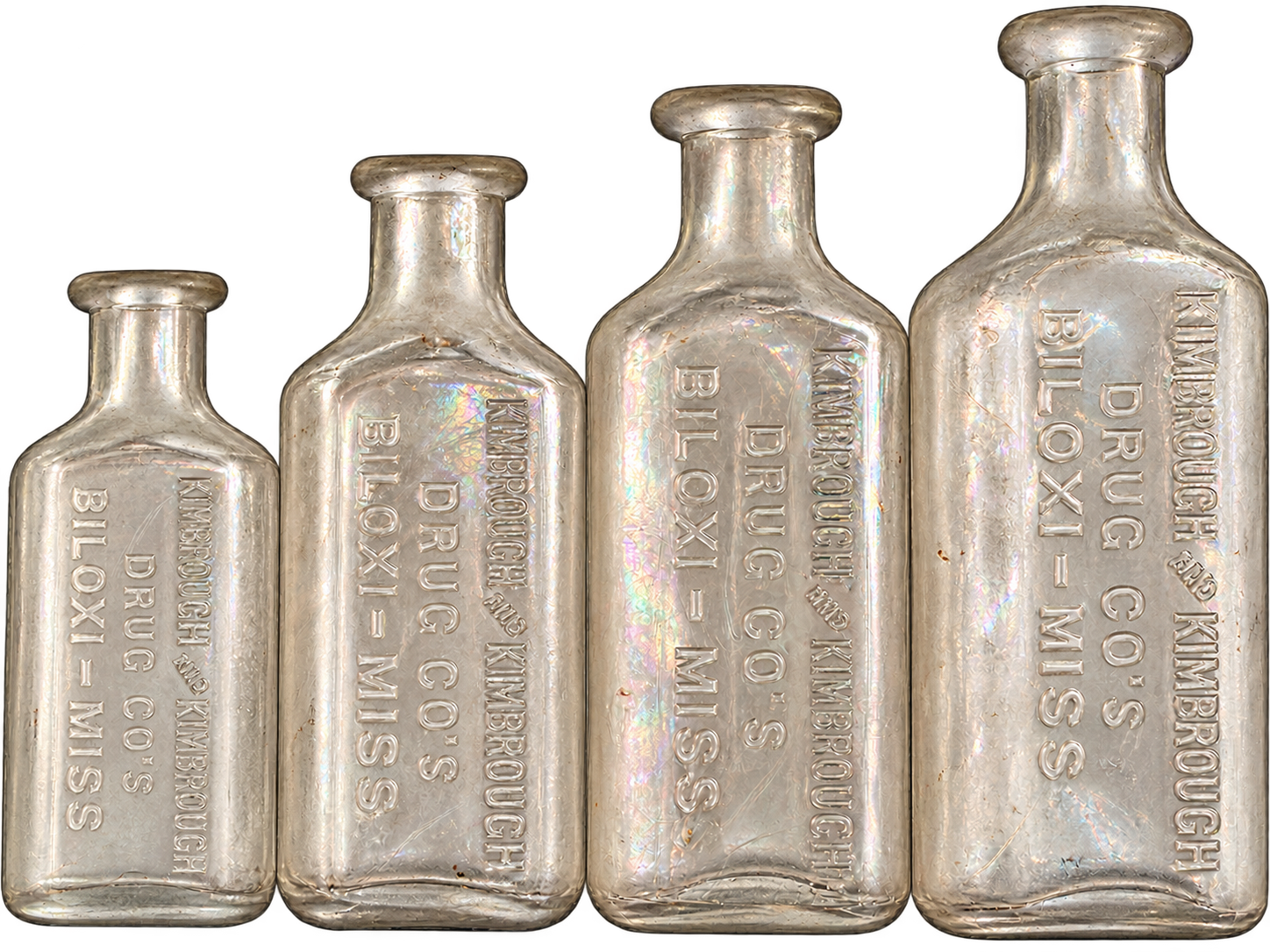 Four Kimbrough Drug Co. embossed glass bottles laid side by side